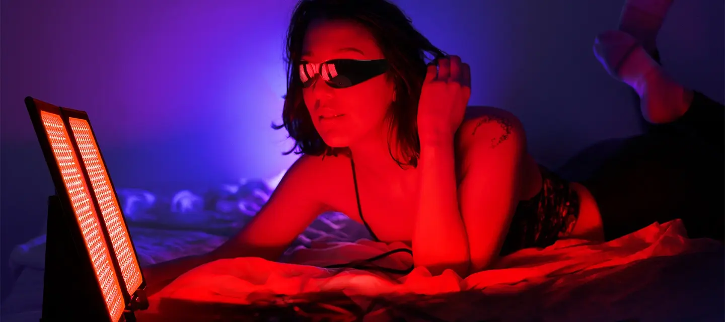 Woman using FAQ Collection dual red light panel